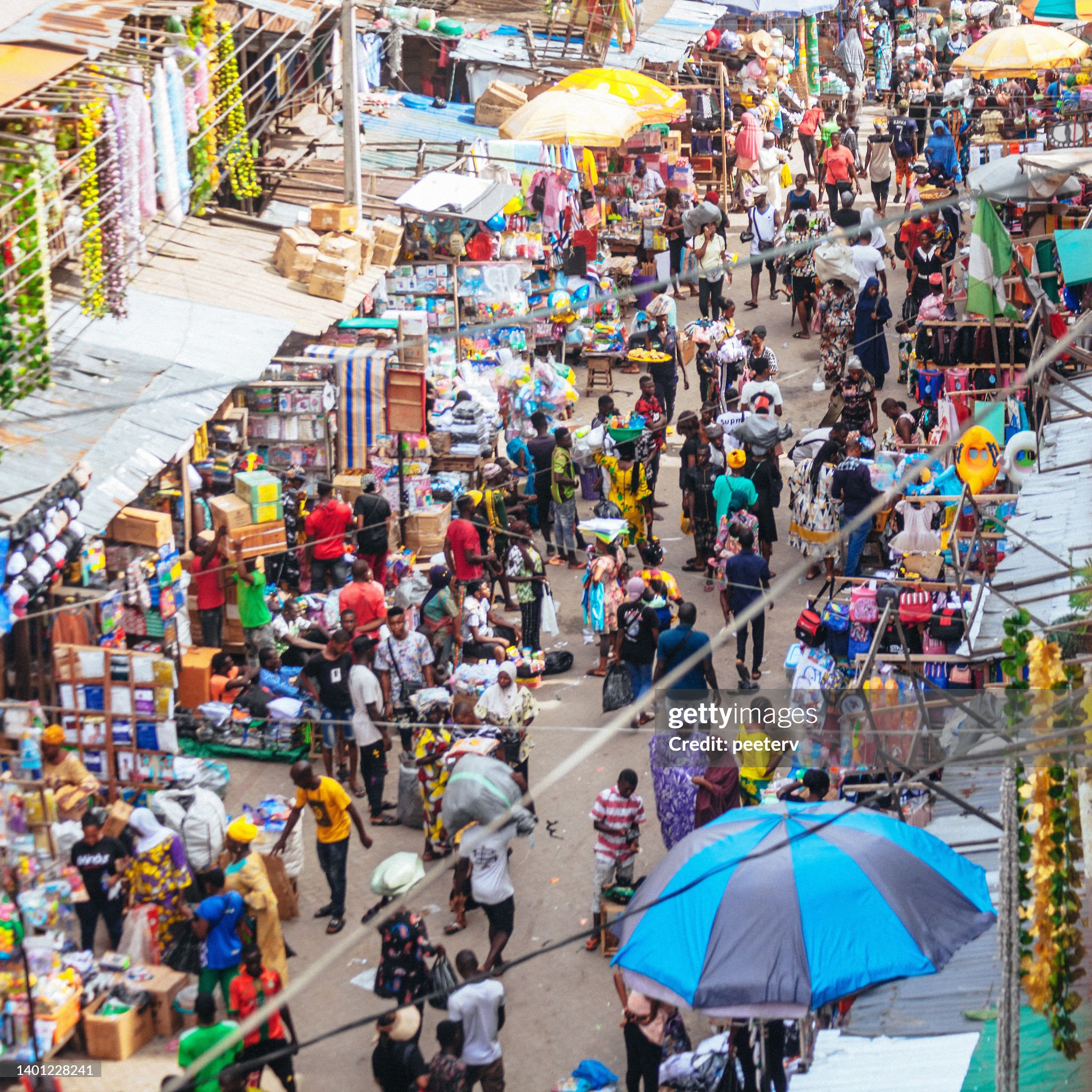 Busy market strees in Lagos, Nigeria, West Africa Welcome to the heart of our community – a bustling marketplace teeming with life and activity. In this vibrant hub of commerce and culture, the need for reliable electricity is paramount. Imagine the possibilities when every stall, every vendor, and every interaction is powered by clean, sustainable energy. Your support for our solar-powered project will illuminate this marketplace and transform lives, ensuring that progress and prosperity shine bright for generations to come. Join us in lighting up our community and empowering its future!